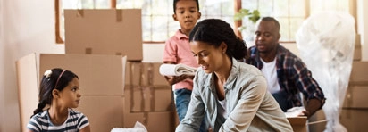 photo of family with moving boxes