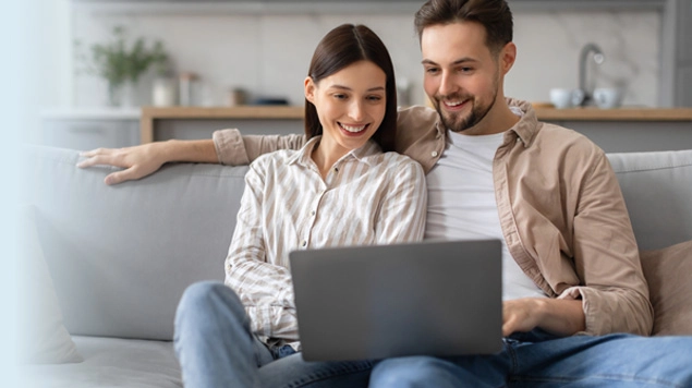 Smiling couple with laptop